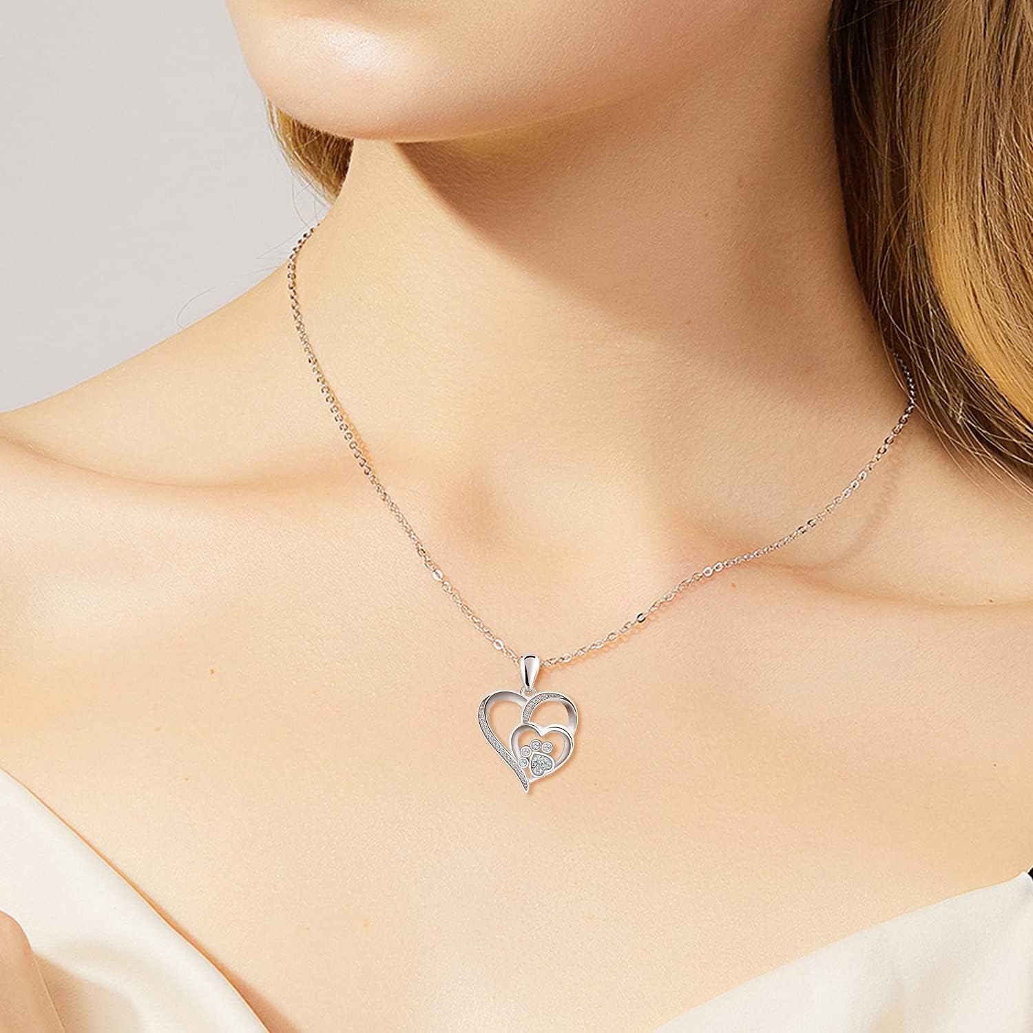 Sterling silver necklace with paw and heart with cubic zirconia